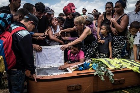 A woman cries during the funeral of her husband, Keiber Cubero, 25. Father to a little girl and struggling to find food, Keiber went to rob a restaurant with two friends during the night. They were caught and killed by police officers while fleeing the scene