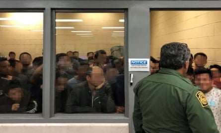 Men are crowded in a room at a Border Patrol station in McAllen, Texas