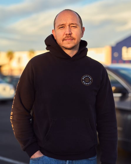 man with mustache in black hoodie