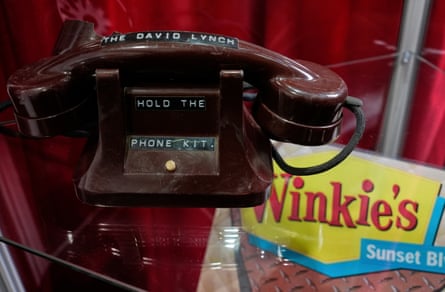 An old-fashioned telephone and printed material in a 50s style that reads 'Winkie’s'
