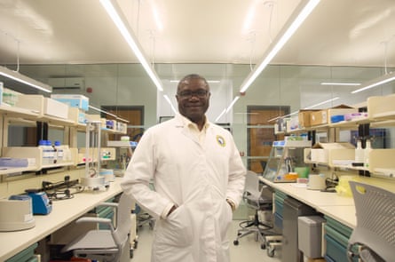 A man stands between two laboratory benches