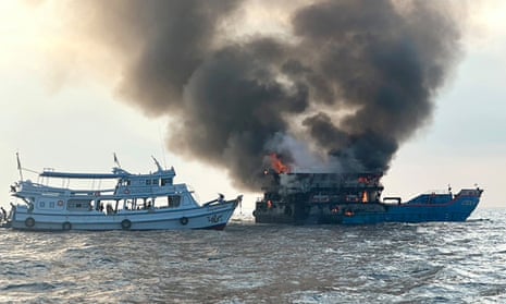 The ferry on fire with another vessel nearby