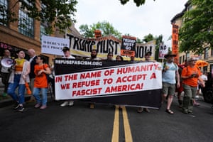 people hold a banner that reads ‘in the name of humanjity, we refuse to accept a fascist America’
