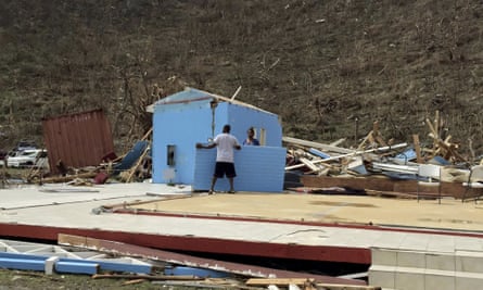 People work surrounded by debris in the aftermath of Hurricane Irma in Tortola.