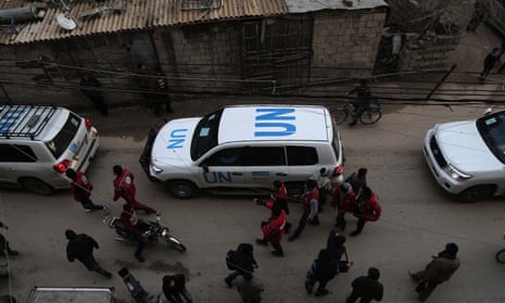 UN vehicles escorting a Red Crescent convoy carrying humanitarian aid for Syrian civilians arrive in a rebel-held area on the outskirts of Damascus in early 2016