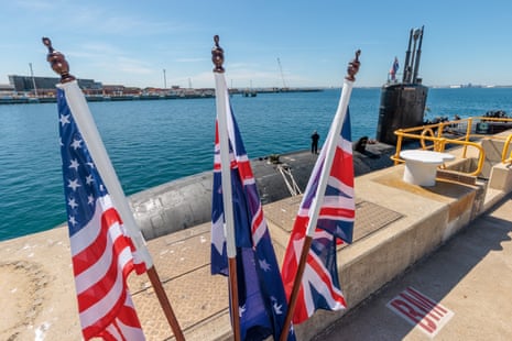 US, Australian and British flags fly alongside a US nuclear-powered submarine at HMAS Stirling in Western Australia