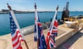 UK, US and Australian flags in front of the USS Ashevilla, a Los Angeles-class nuclear powered submarine, in WA