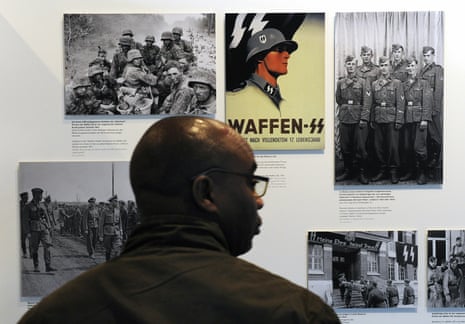 A visitor looks at photographs of SS troops and Nazi propaganda at the Topography of Terror museum in Berlin.