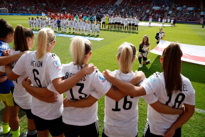 Northern Ireland and Austria players line up before the match as their national flags are displayed.