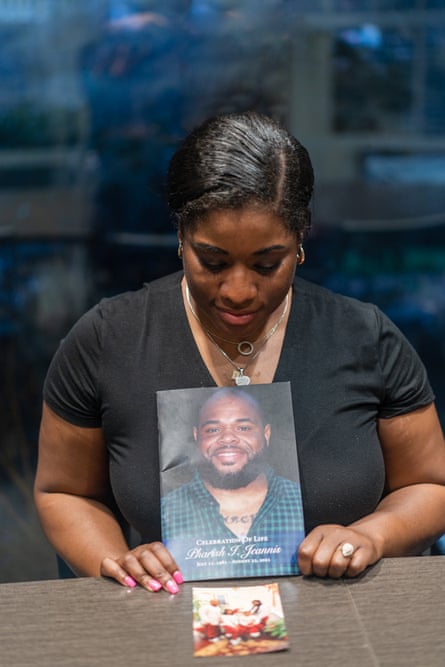 Elashia Hall-Jeannis holds the program from the 2021 celebration of life for her husband, Pharish Jeannis.