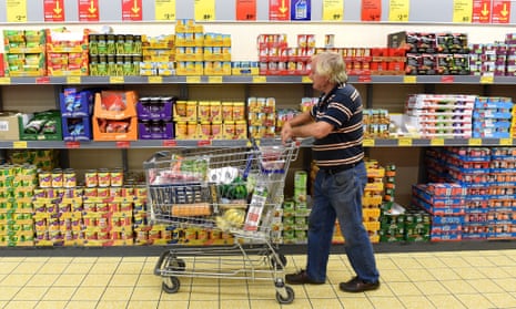 man with a shopping trolley in a supermarket