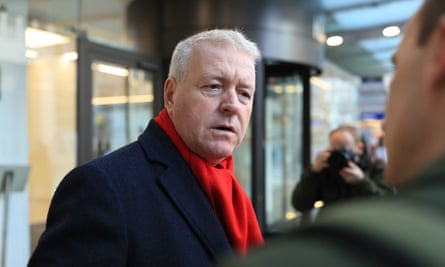 Ian Lavery outdoors wearing a heavy overcoat and a red scarf