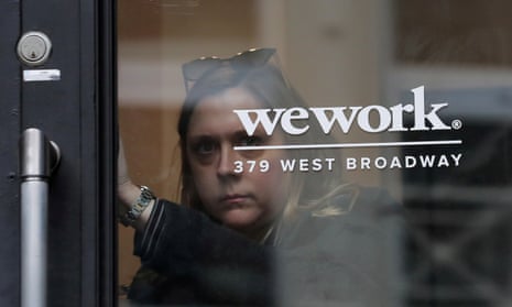 A woman exits a WeWork co-working space in New York City