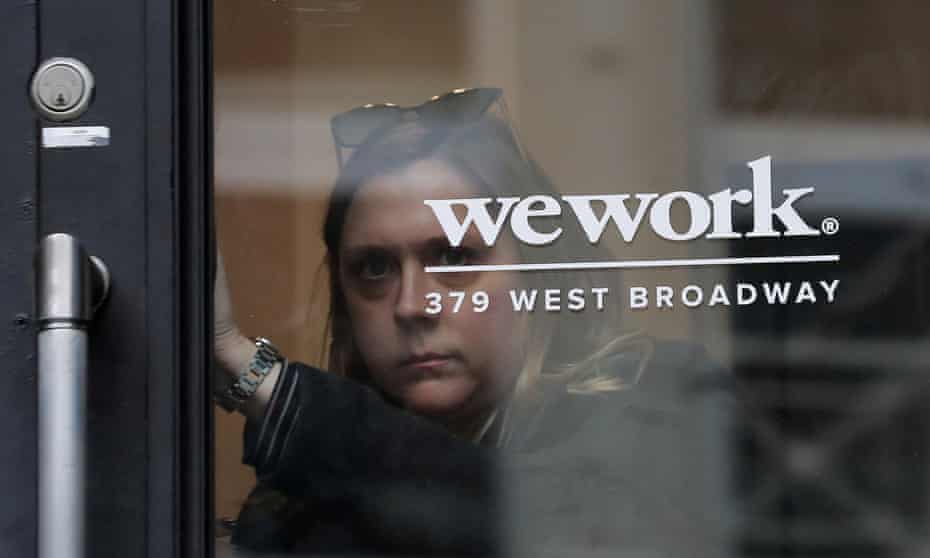 A woman exits a WeWork co-working space in New York City