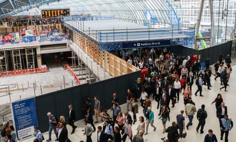 Commuters walk past closed platforms at Waterloo station.