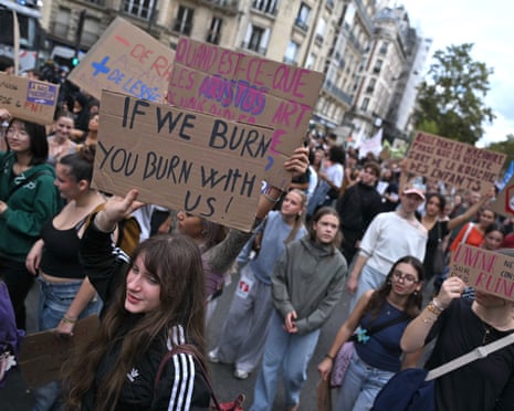 A protester holds a poster reading ‘if we burn you burn with us' as high school students and members of French unions march during a national day of protest against education conditions in Paris, France.