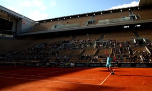 Rafael Nadal serves.