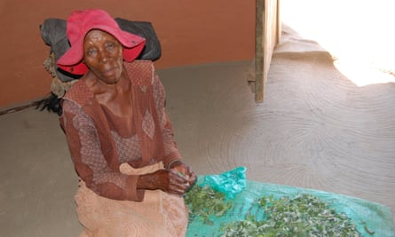 Marentseng Tjamela prepares a meal of vegetables and pap for her orphan grandchildren in Mafeteng