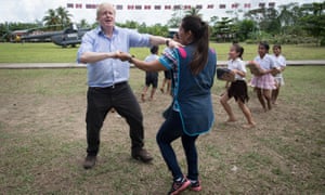 Boris Johnson dances with teacher Adriana Pinedo during a visit to the village school in Santa Marta, near Iquitos in Peru