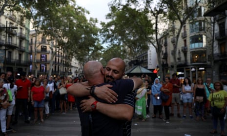 A Muslim man hugs passers-by at the site of the terrorist incident on the Ramblas in Barcelona