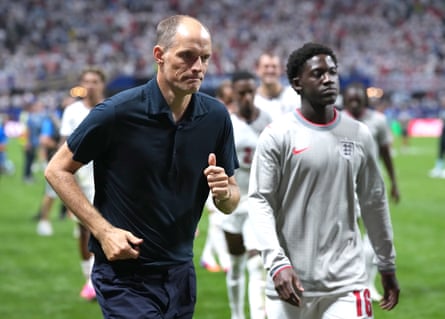 Thomas Tuchel and Kobbie Mainoo walk off the pitch after England's defeat by Argentina at the World Cup