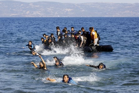 Afghan refugees swim ashore as their dinghy with a broken engine drifts off the Greek island of Lesbos during a crossing of the Aegean Sea from Turkey.
