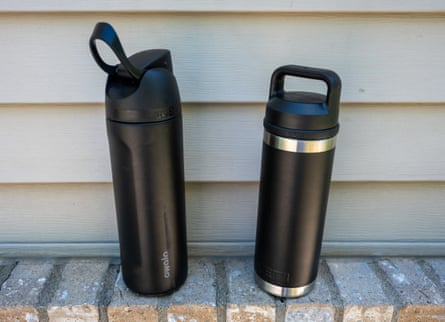 two black reusable water bottles outside