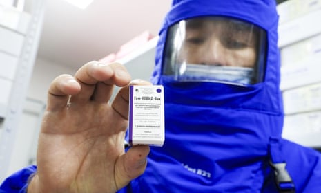 A worker holds a pack of the Russian Gam-COVID-Vac (Sputnik V) vaccine against COVID-19 stored in a cold room.