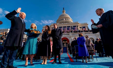 Joe Biden is sworn in as the 46th president of the US by the chief justice, John Roberts, as his wife Dr Jill Biden holds the Bible, alongside son Hunter and daughter of Joe and Jill Biden, Ashley, during the 59th presidential inauguration at the US Capitol in Washington DC