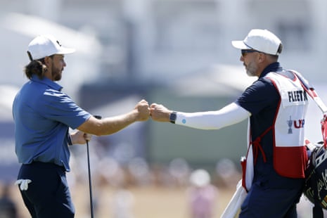 Tommy Fleetwood celebrates with caddie Ian Finnis after his eagle putt.