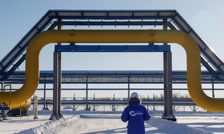 An employee walks past a part of Gazprom's Power Of Siberia gas pipeline