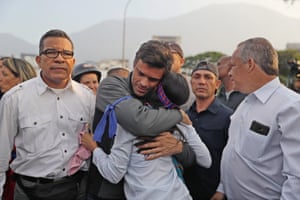 Opposition leader Leopoldo Lopez hugs a supporter after being released from house arrest at his home in Caracas