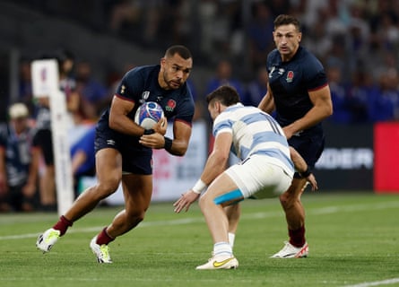 Joe Marchant runs at an Argentina player holding the ball