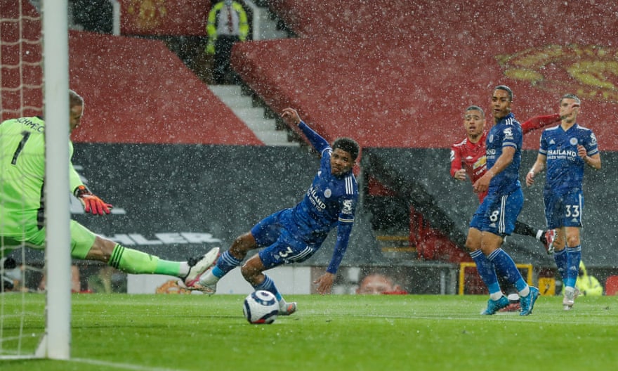 Mason Greenwood hits his shot through the heavy rain and past Leicester goalkeeper Kasper Schmeichel.