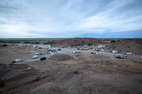 A mass of vans and buses parked in an open space
