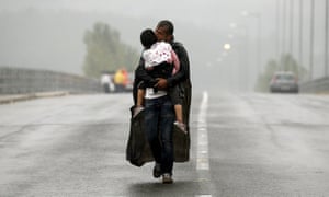 One of Yannis Behrakisâ€™s most celebrated photos â€“ of a Syrian refugee carrying his daughter towards Greeceâ€™s border with Macedonia, 2015.