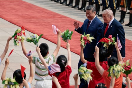 Donald Trump walks with Xi Jinping during a welcome ceremony at the Great Hall of the People.