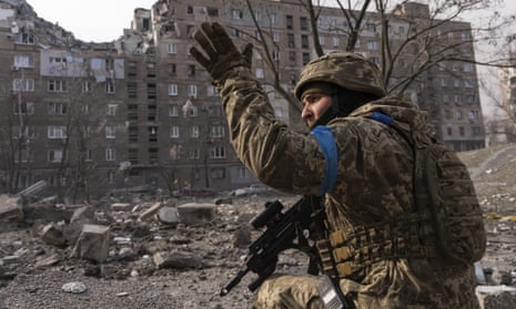 A Ukrainian service member guards his position in Mariupol.