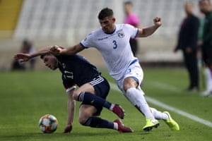 Cyprus’ Nicholas Ioannou challenges Ryan Christie.