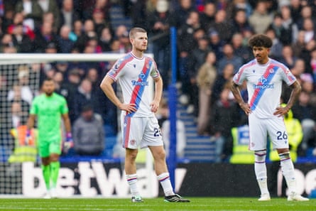 Crystal Palace's Adam Wharton and teammate stand dejected after conceding a goal