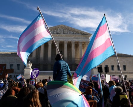 Demonstrators carry transgender flags outside the US supreme court.