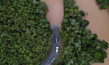 Cars stop before a flooded area, after Cyclone Batsirai made landfall