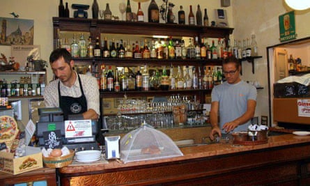 Staff behind the counter at the Turin bar-tavern Caffe Vini Emilio Ranzini. Italy.