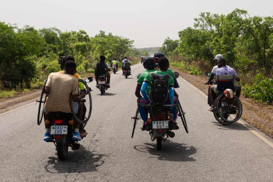 Motorbikes support riders with water and spare wheels.