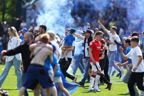 Stockport County fans celebrate on the pitch after their team's win against Salford City in their EFL Sky Bet League Two Play-Off Semi Final, Second Leg.