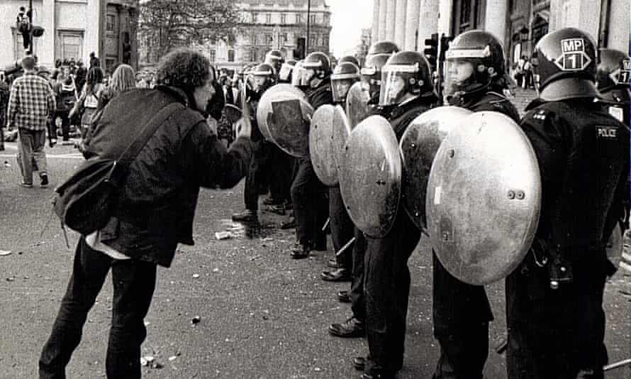 Harry Harrison addresses riot police during a CJB demonstration in Trafalgar Square, 1994.