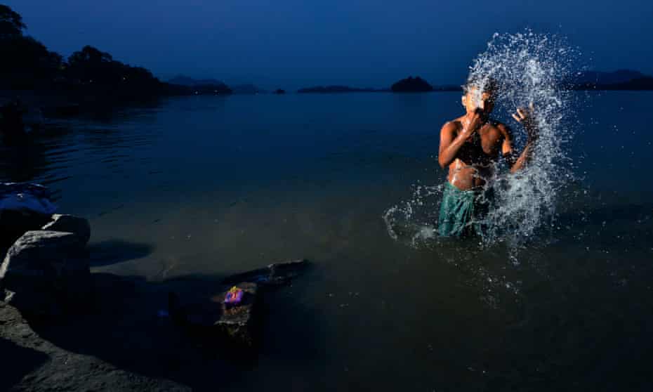 A man washes in the Brahmaputra river in Guwahati, Assam. India is embarking on a massive rivers diversion project to alleviate flooding and drought.