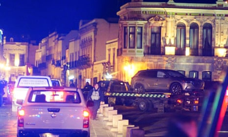 Police forces remove an SUV with bodies that were left by unknown assailants in front of the government palace, in Zacatecas, Mexico, on Thursday.