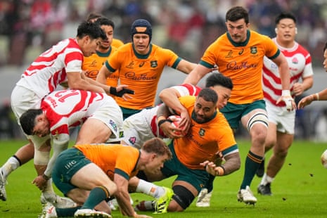 Australia's Lukhan Salakaia-Loto is tackled by defenders after making a run