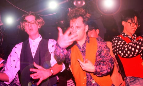 Three men in waistcoasts dancing at the Haçienda nightclub in 1988
